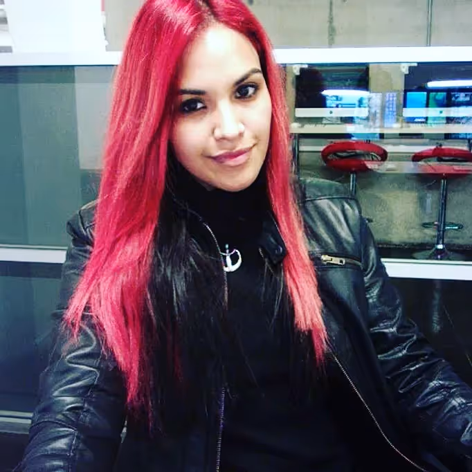 Paula in college, with pink hair